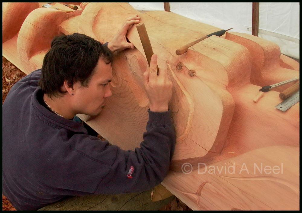 The artist carving a totem pole from a 500 year old red cedar log.